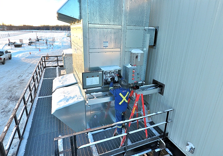 Worker adjusting valves on equipment