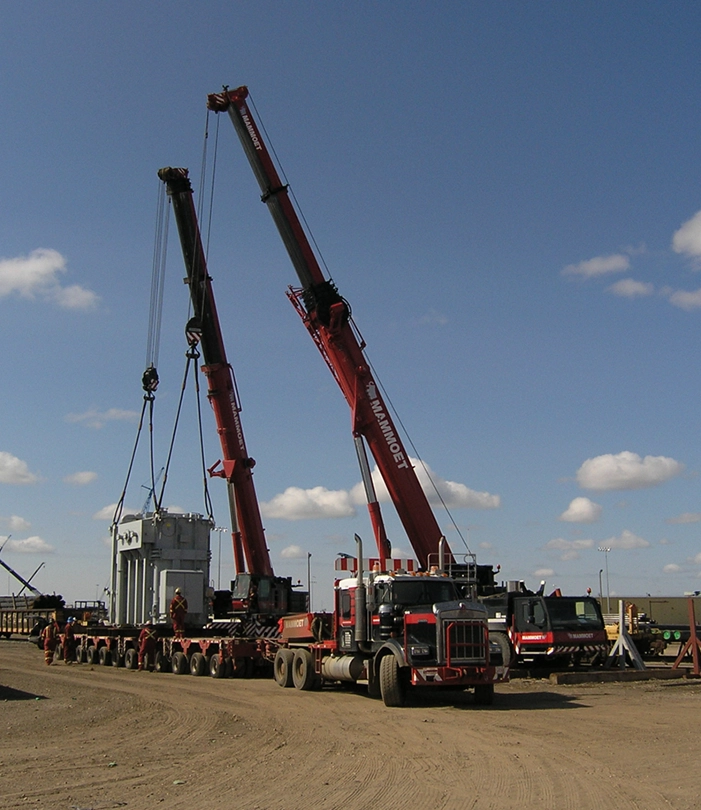 Two cranes operating on worksite