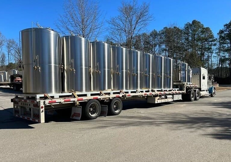 Kathairos truck hauling several steel tanks